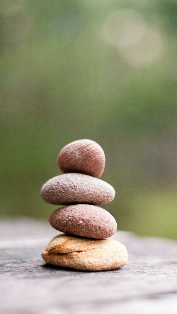 Balance and tranquility embodied by stacked stones in a natural outdoor setting.